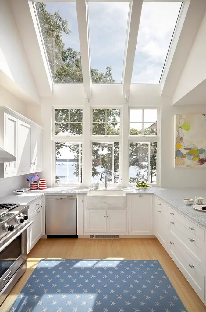 Luxury and bright kitchen in white opens up towards the view outside