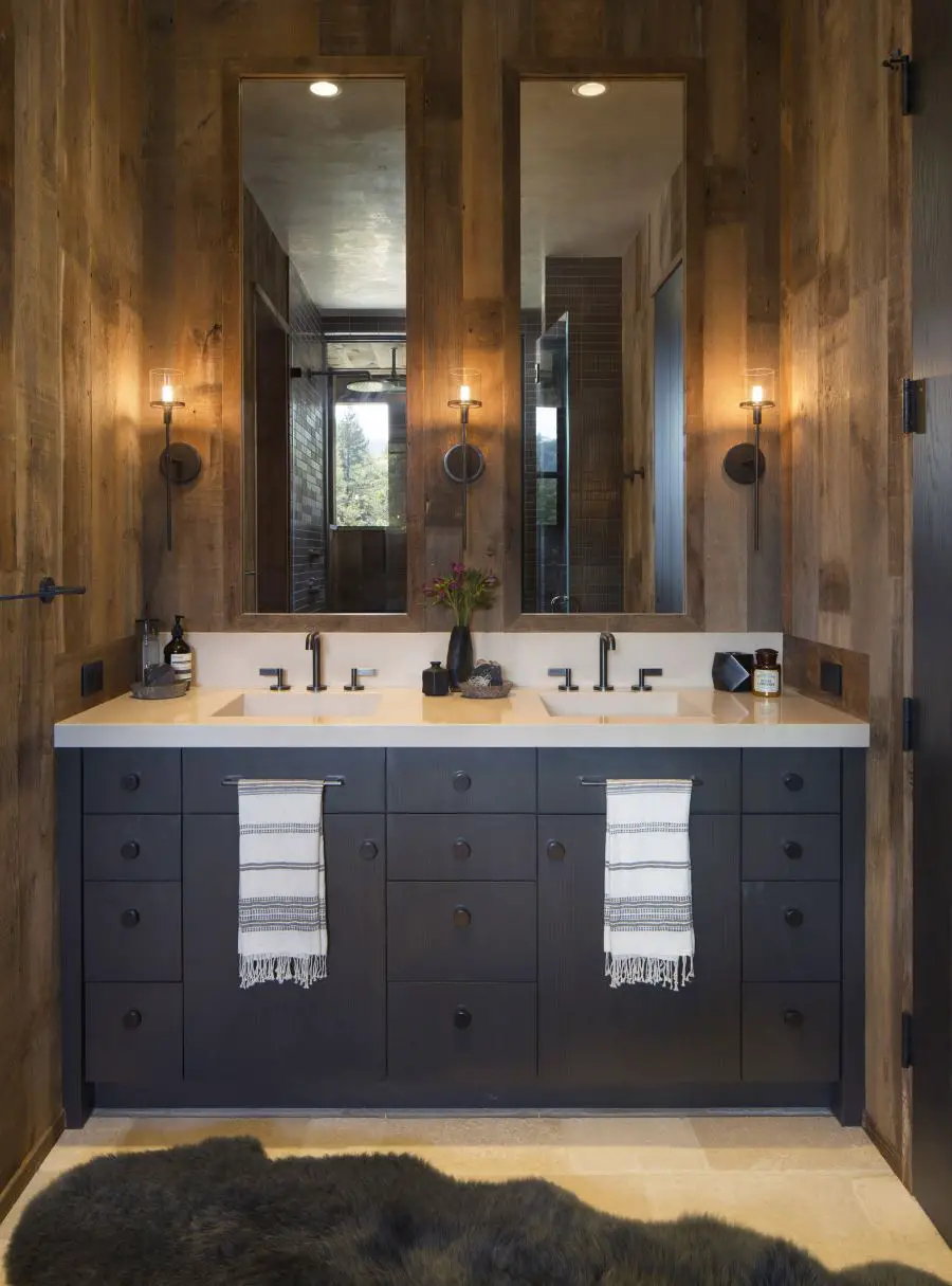 Farmhouse Bathroom . Beautiful wood walls, grey vanity, dark tiles and cabinet. A beautiful example of a farmhouse bathroom interior.